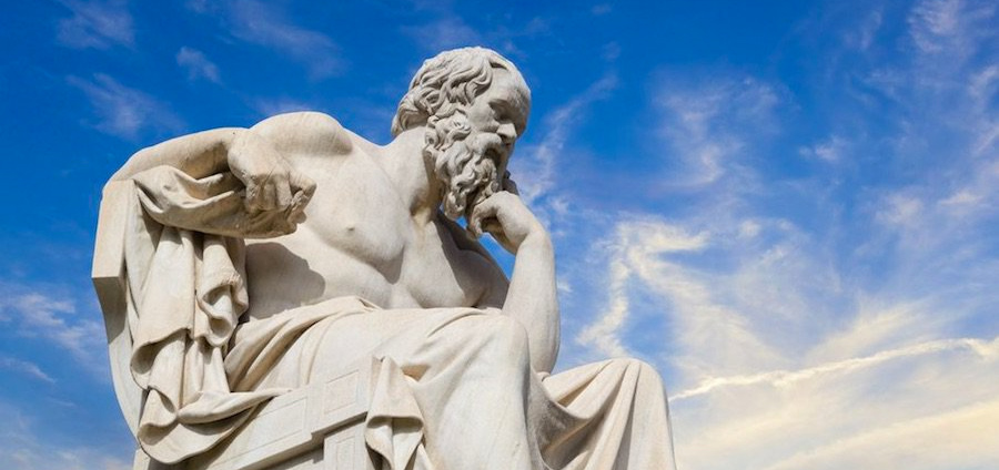 Statue of a philosopher thinking with blue sky background